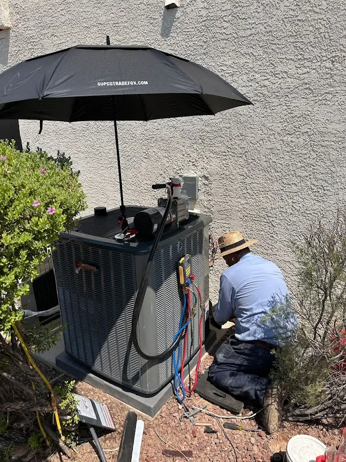 HVAC technician performing outdoor AC maintenance in Los Alamitos