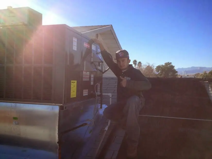 HVAC technician performing HVAC Inspection on a rooftop unit in Los Alamitos